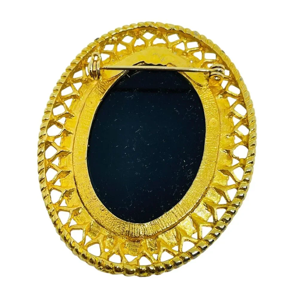 Vintage gold tone molded glass black cameo brooch